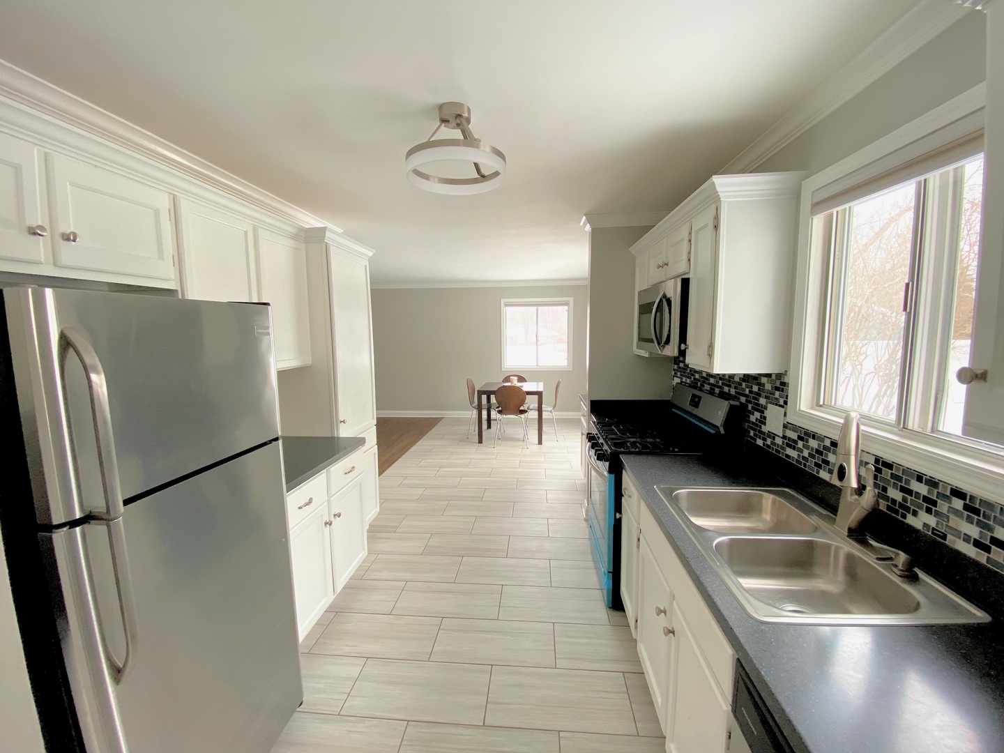 1214 Needham Road Naperville, IL 60563 - Photo 16 of 25 a kitchen with stainless steel appliances granite countertop a refrigerator a sink a stove and white cabinets with wooden floor