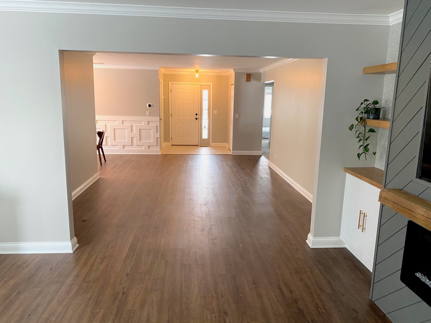 1214 Needham Road Naperville, IL 60563 - Photo 8 of 25 a view of a hallway with wooden floor and a fireplace