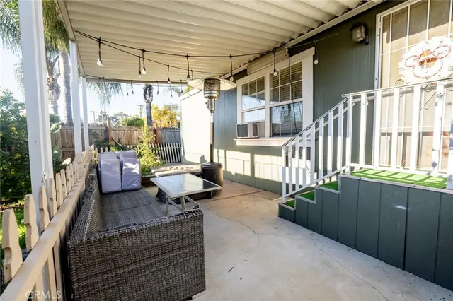a balcony with furniture and a potted plant