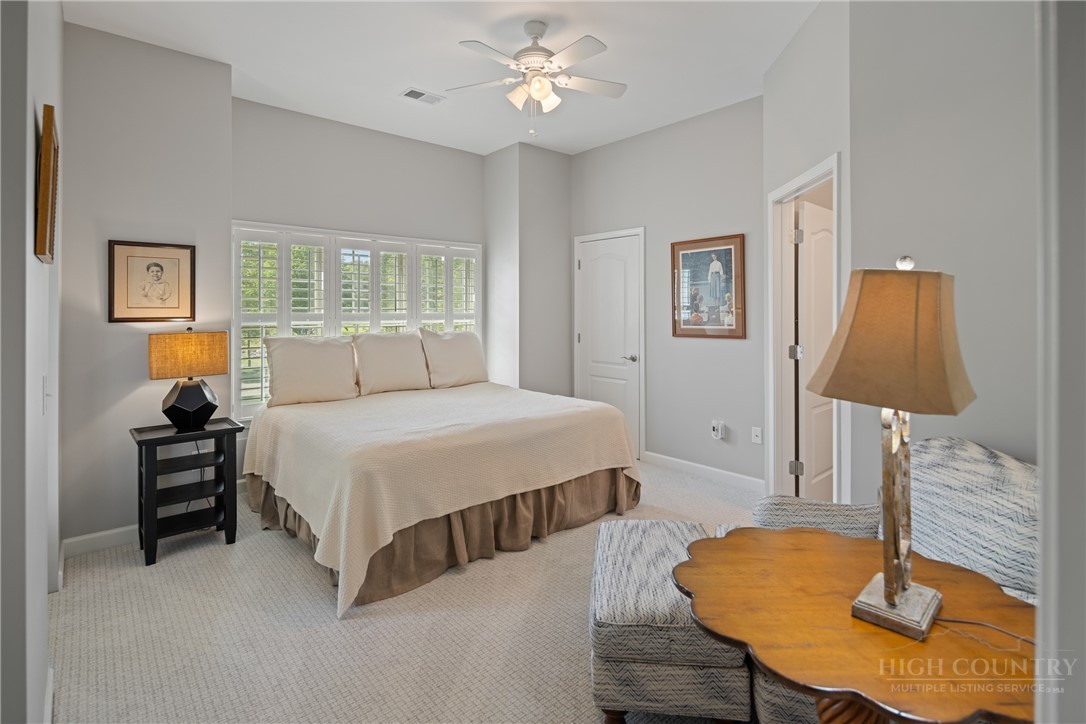 147 Riverside Park Court, Unit G2 Jefferson, NC 28640 - Photo 33 of 44 a spacious bedroom with a bed and a table in it