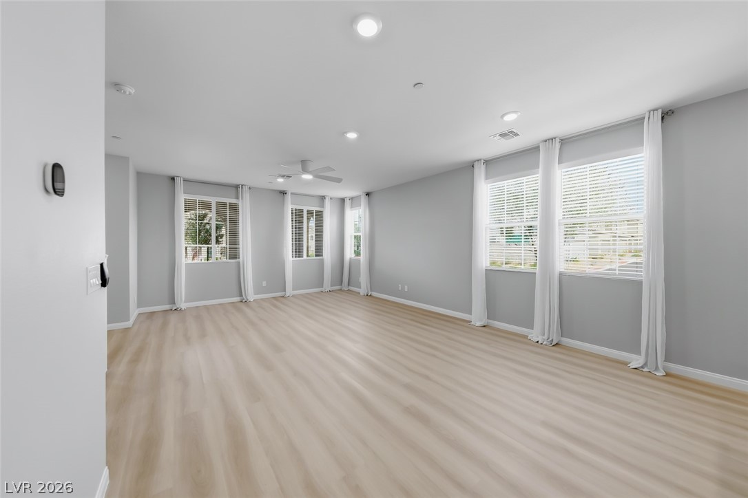 3564 Credere Lane Henderson, NV 89074 - Photo 8 of 40 Unfurnished living room with ceiling fan, light wood-style floors, and recessed lighting