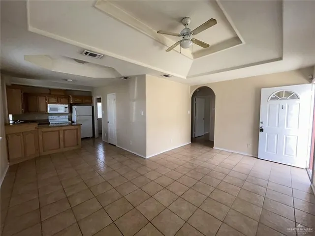 a view of a livingroom with a furniture wooden floor and a ceiling fan