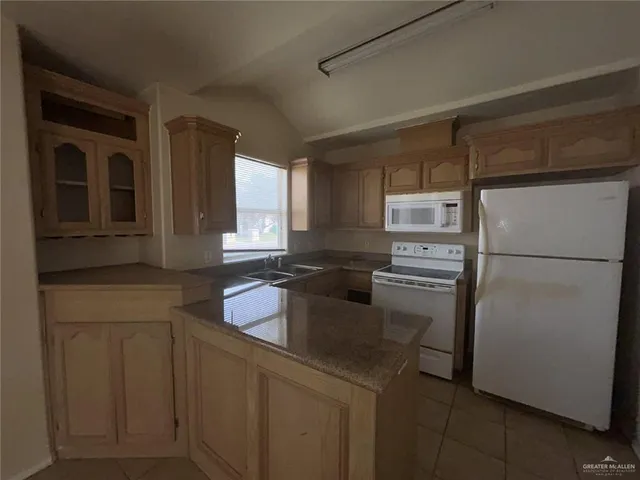 a kitchen with a refrigerator sink and stove
