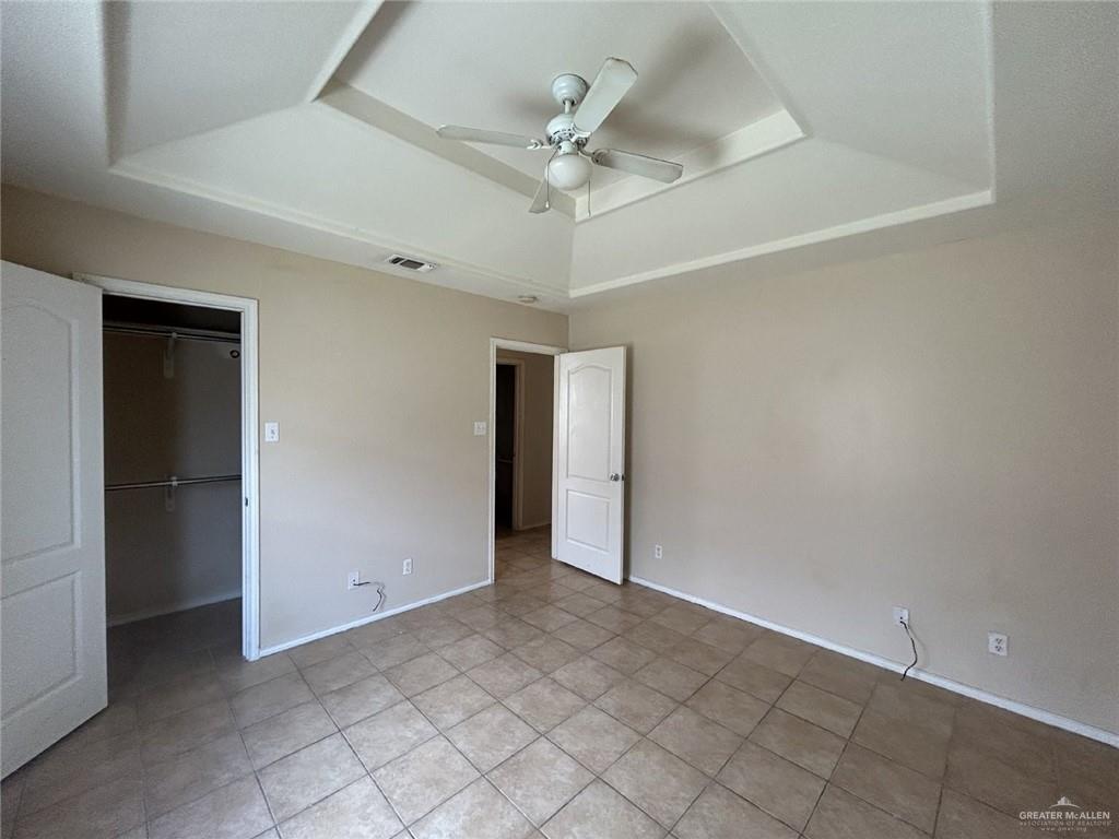 1803 Douglas, Unit 3 Pharr, TX 78577 - Photo 8 of 11 an empty room with a ceiling fan and a window
