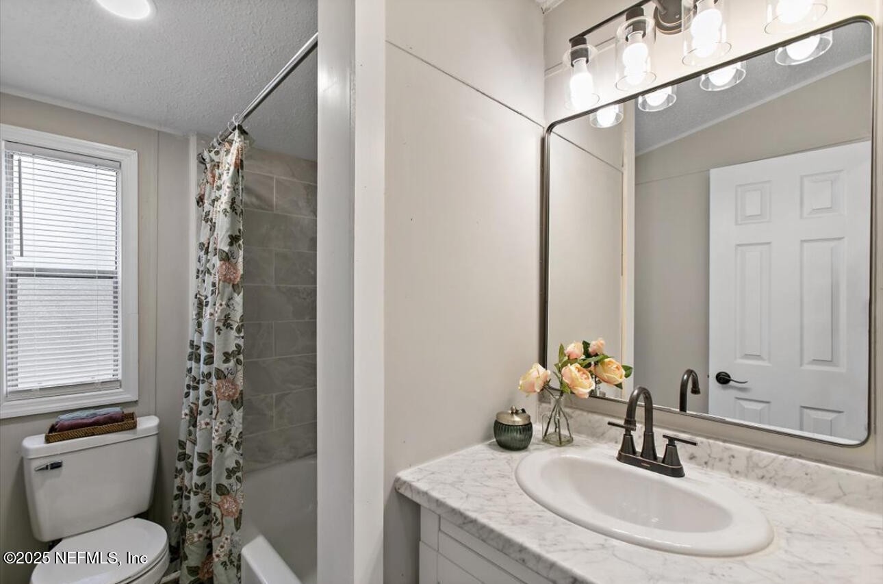 3032 Snell Street Jacksonville, FL 32218 - Photo 11 of 17 a bathroom with a sink toilet and shower