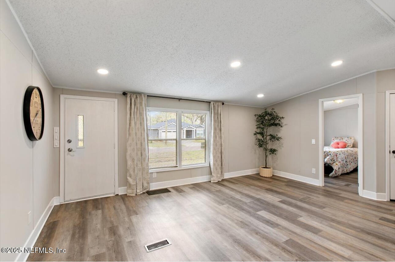 3032 Snell Street Jacksonville, FL 32218 - Photo 3 of 17 a view of a room with wooden floor and window