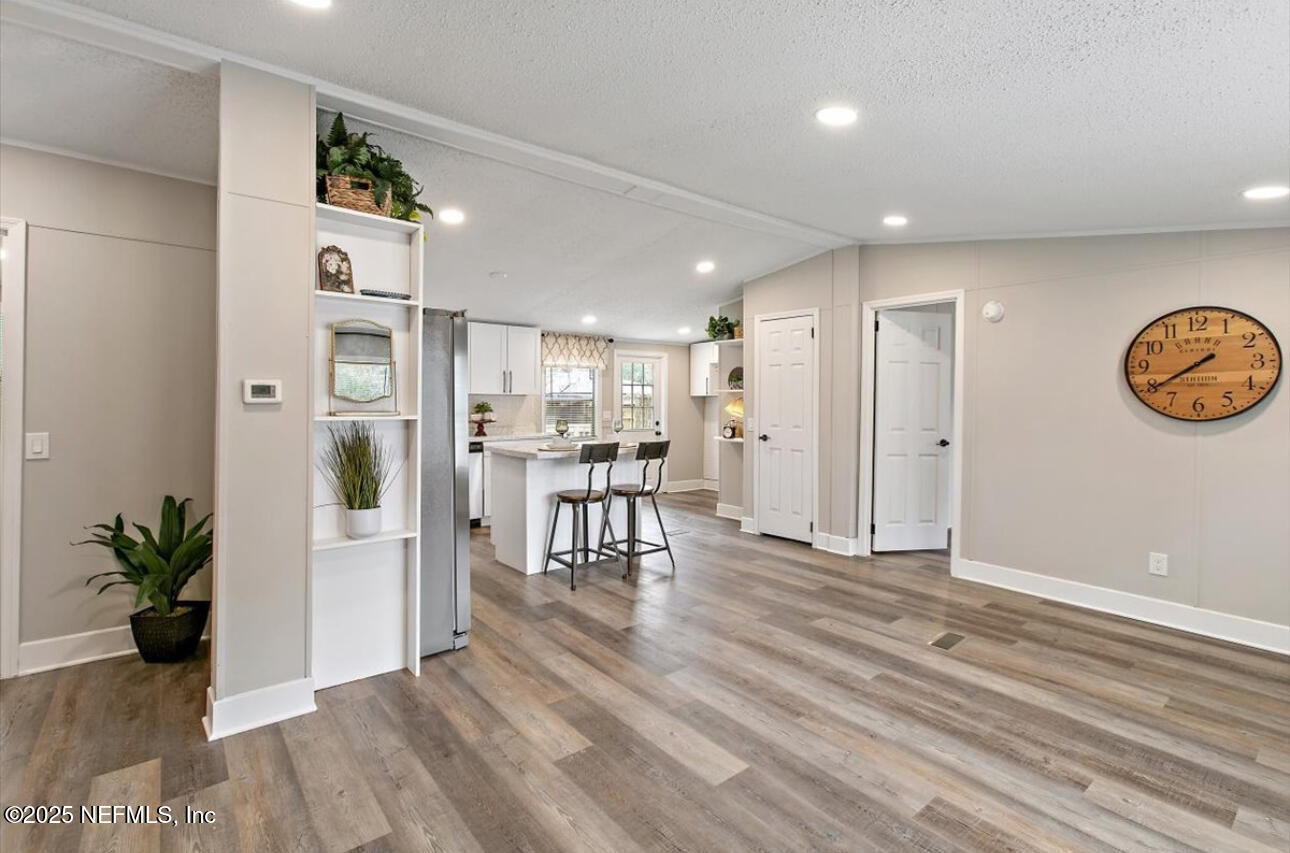 3032 Snell Street Jacksonville, FL 32218 - Photo 5 of 17 a view of a room with wooden floor and a hallway