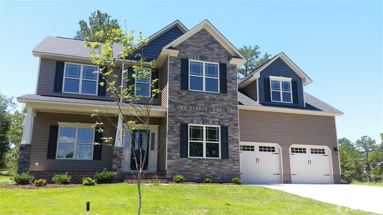 219 Spring Flowers Drive Cameron, NC 28326 - Photo 1 of 12 a front view of a house with garden