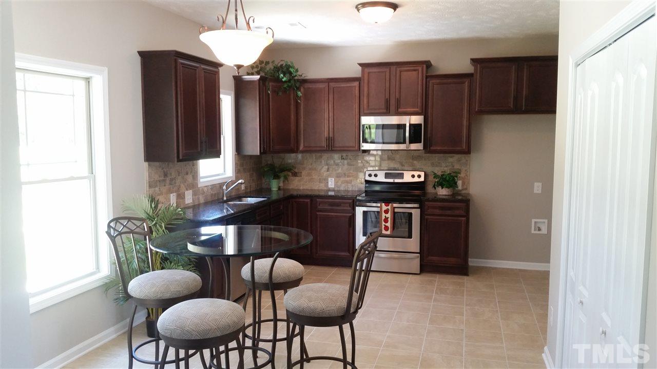 219 Spring Flowers Drive Cameron, NC 28326 - Photo 4 of 12 a kitchen with a refrigerator cabinets and a sink