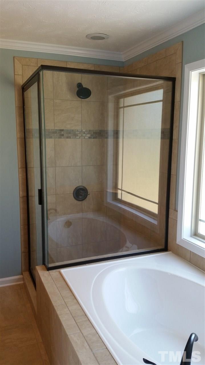 219 Spring Flowers Drive Cameron, NC 28326 - Photo 9 of 12 a bathroom with a bathtub