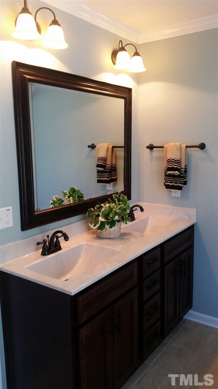 219 Spring Flowers Drive Cameron, NC 28326 - Photo 10 of 12 a bathroom with a sink and a mirror