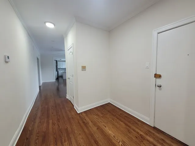a view of a room with wooden floor