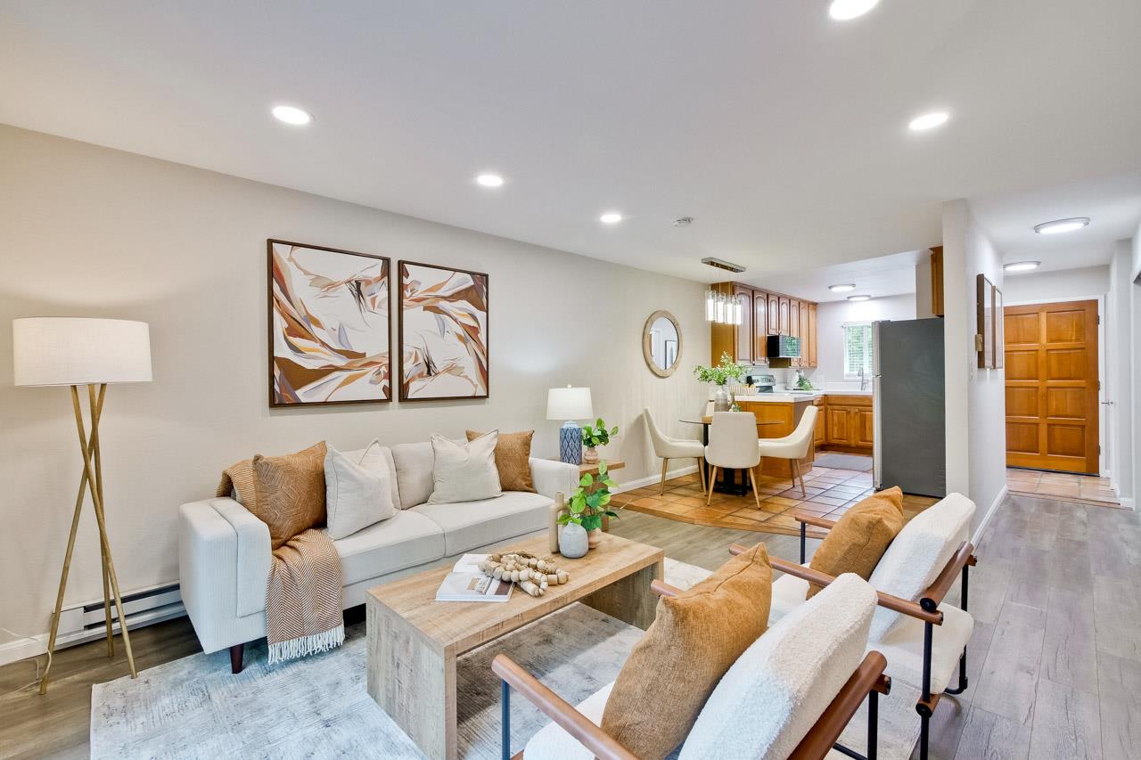 1046 Wright Avenue, Unit J Mountain View, CA 94043 - Photo 2 of 36 a living room with furniture a table and a painting on the wall