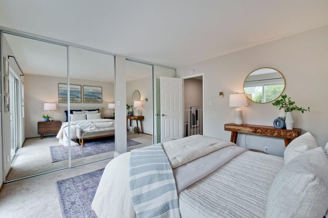 1046 Wright Avenue, Unit J Mountain View, CA 94043 - Photo 24 of 36 a bedroom with furniture and a mirror