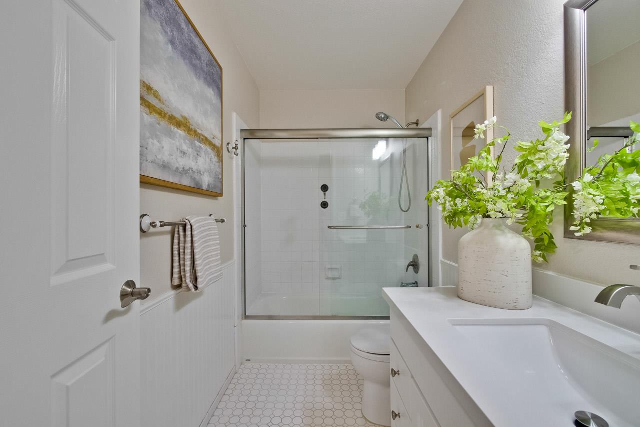 1046 Wright Avenue, Unit J Mountain View, CA 94043 - Photo 27 of 36 a bathroom with a granite countertop sink a toilet and shower