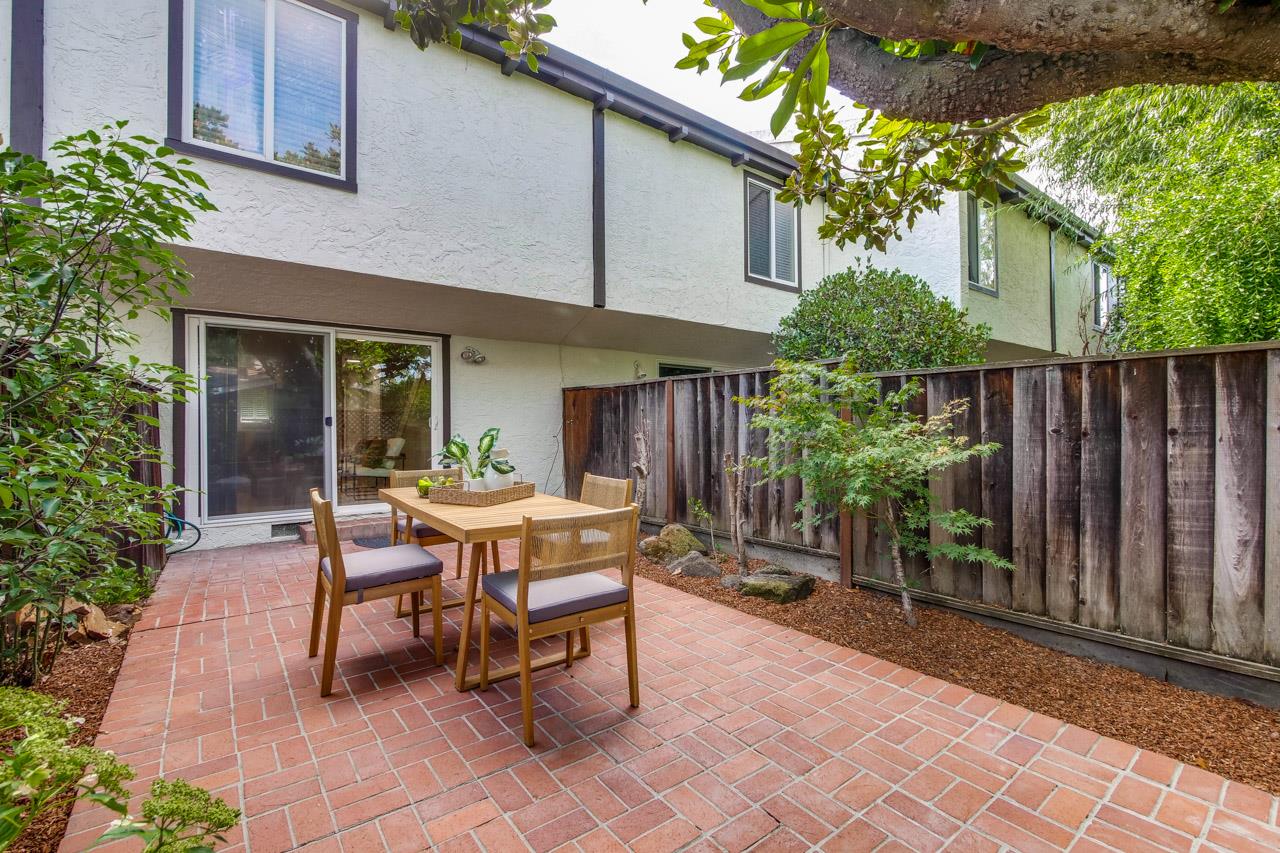 1046 Wright Avenue, Unit J Mountain View, CA 94043 - Photo 31 of 36 a view of a patio with table and chairs and potted plants