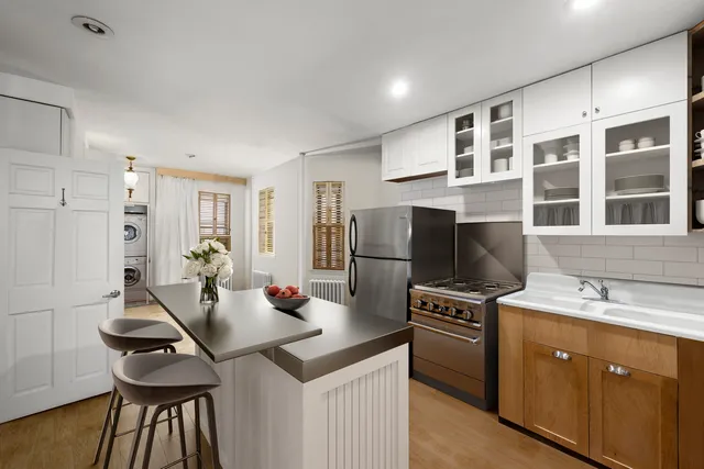 a kitchen with stainless steel appliances cabinets a sink and a stove