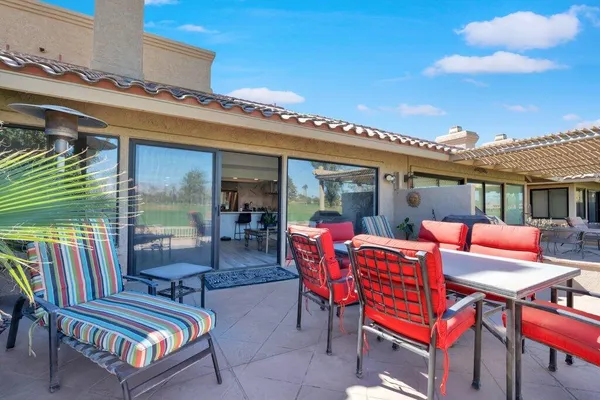 a backyard of a house with outdoor seating