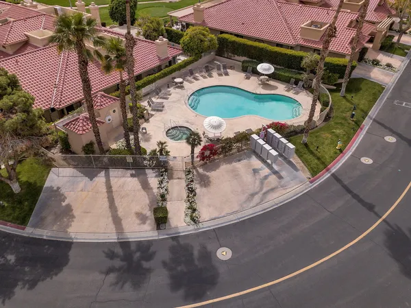 an aerial view of a house with a swimming pool