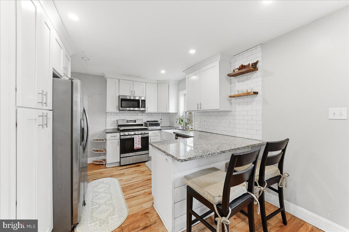 601 Willowbrook Road Havertown, PA 19083 - Photo 8 of 25 a kitchen with stainless steel appliances granite countertop a stove a sink a microwave and a refrigerator