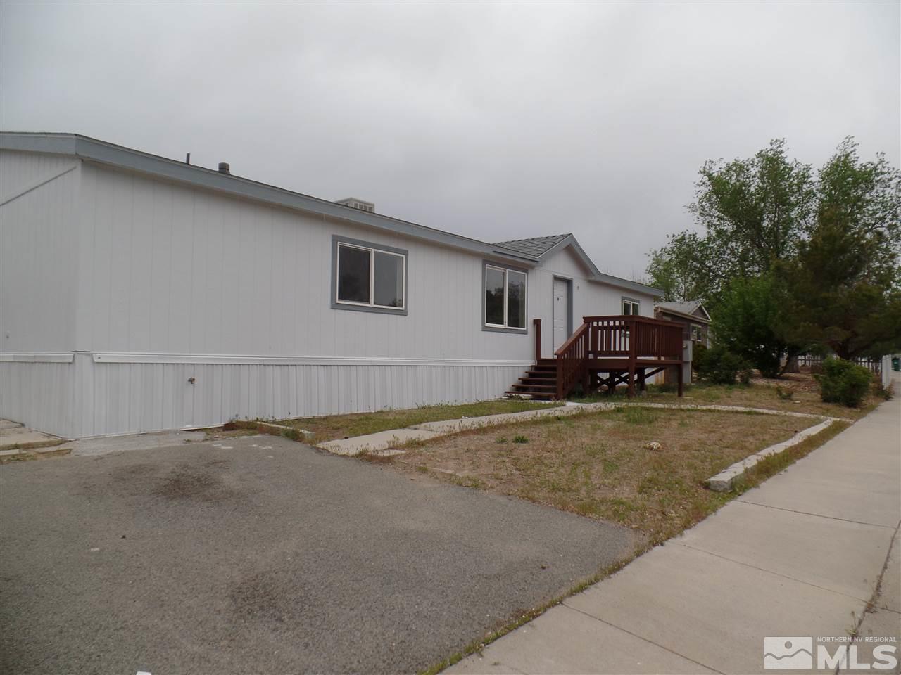 1055 Chisholm Trail Reno, NV 89506 - Photo 1 of 9 a view of a house with a yard and garage