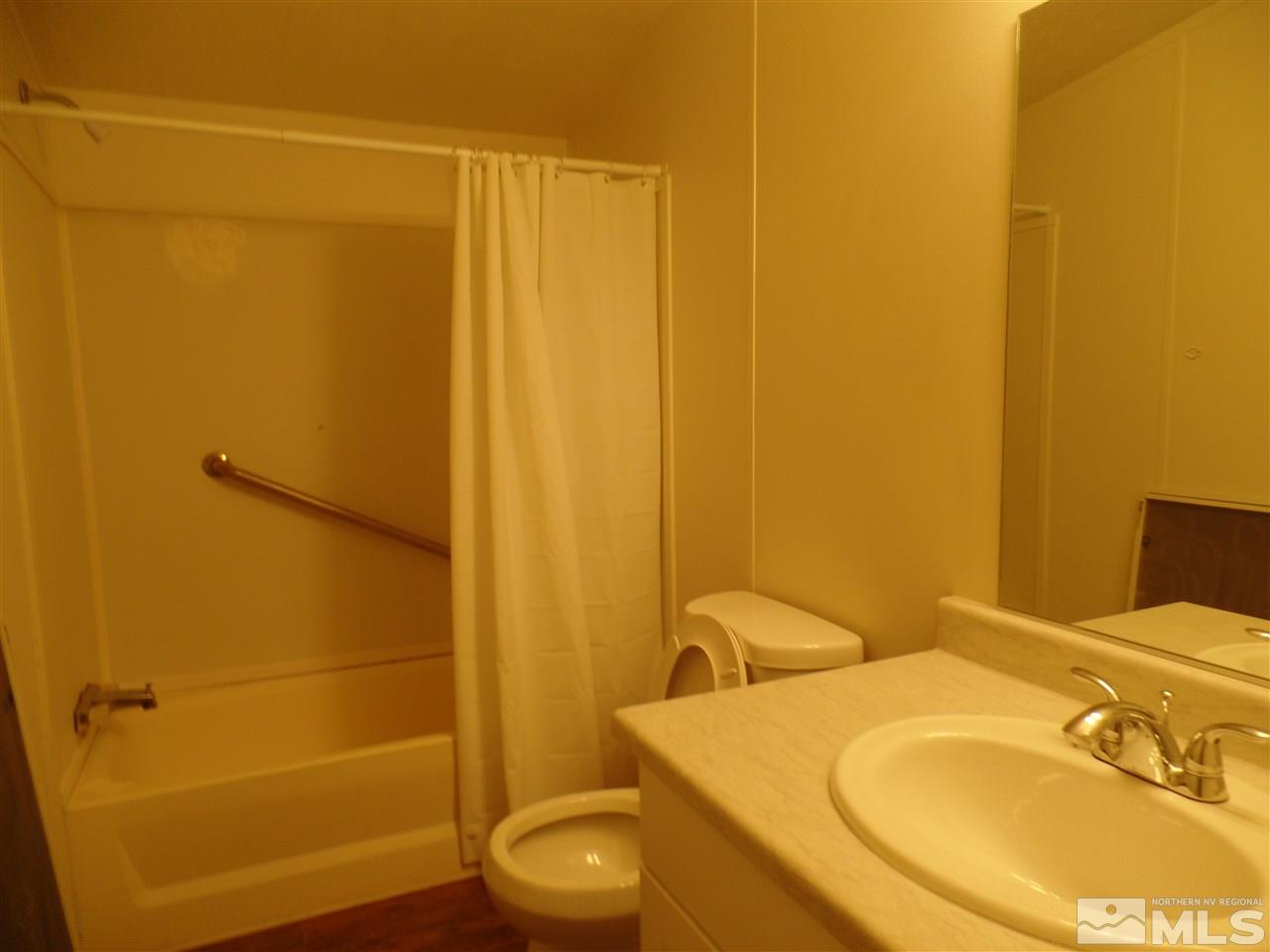 1055 Chisholm Trail Reno, NV 89506 - Photo 6 of 9 a bathroom with a sink and a mirror