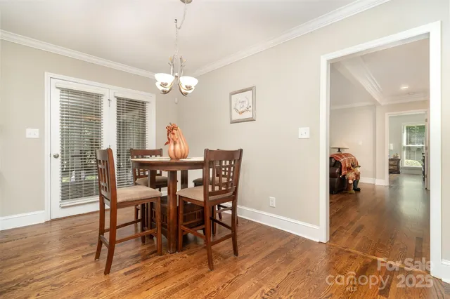 a view of a dining room with furniture wooden floor and chandelier