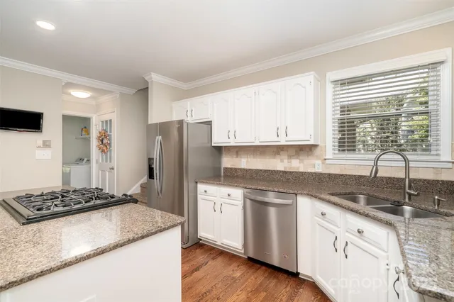 a kitchen with a sink stove and refrigerator