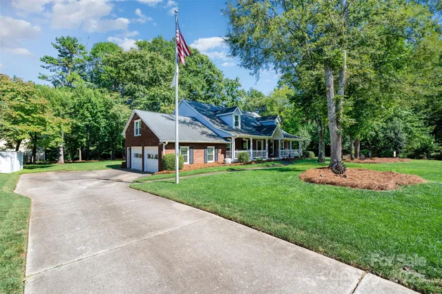 a front view of a house with yard and green space