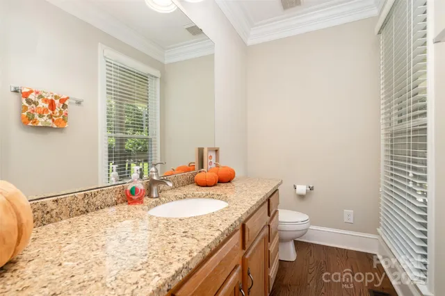 a bathroom with a granite countertop sink a toilet and a bathtub