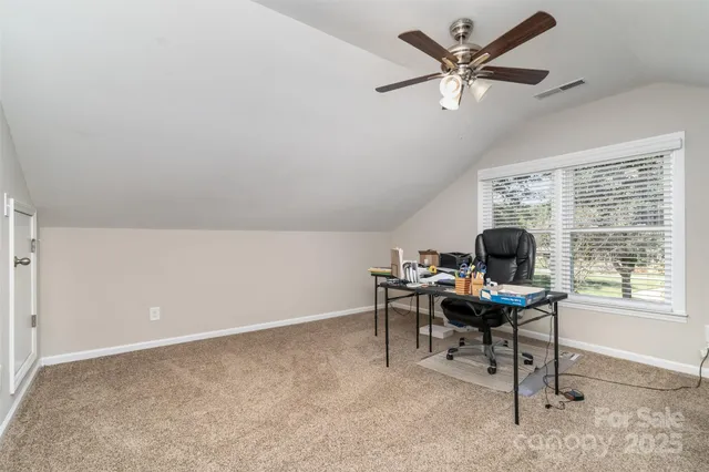 a work room with furniture and a large window