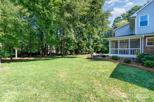 a view of a house with backyard and sitting area