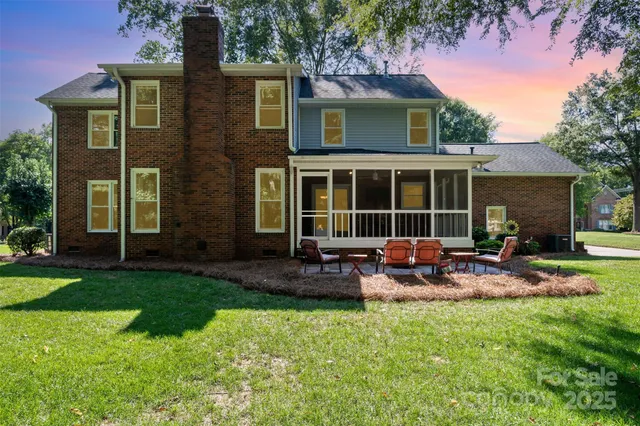 a front view of a house with patio and garden