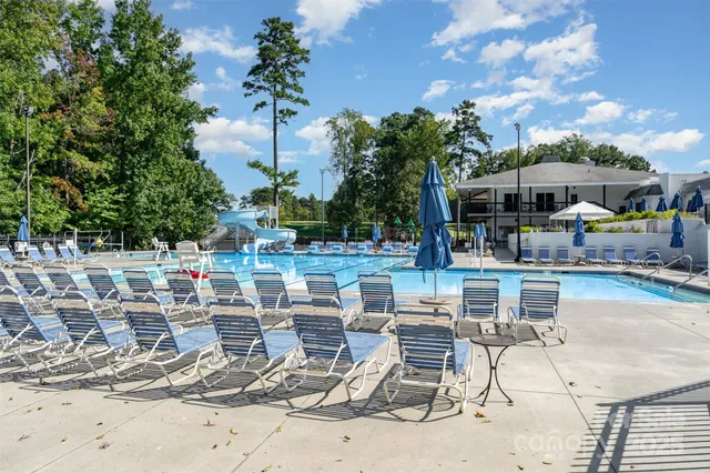 a view of a patio with table and chairs potted plants and palm tree