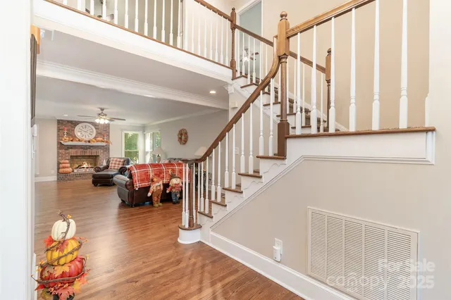 a view of entryway and hall with wooden floor