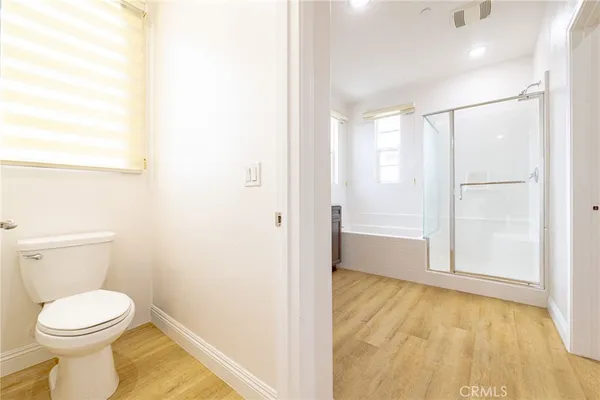 a bathroom with a toilet and a shower