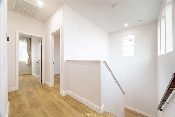 a view of hallway with stairs and wooden floor