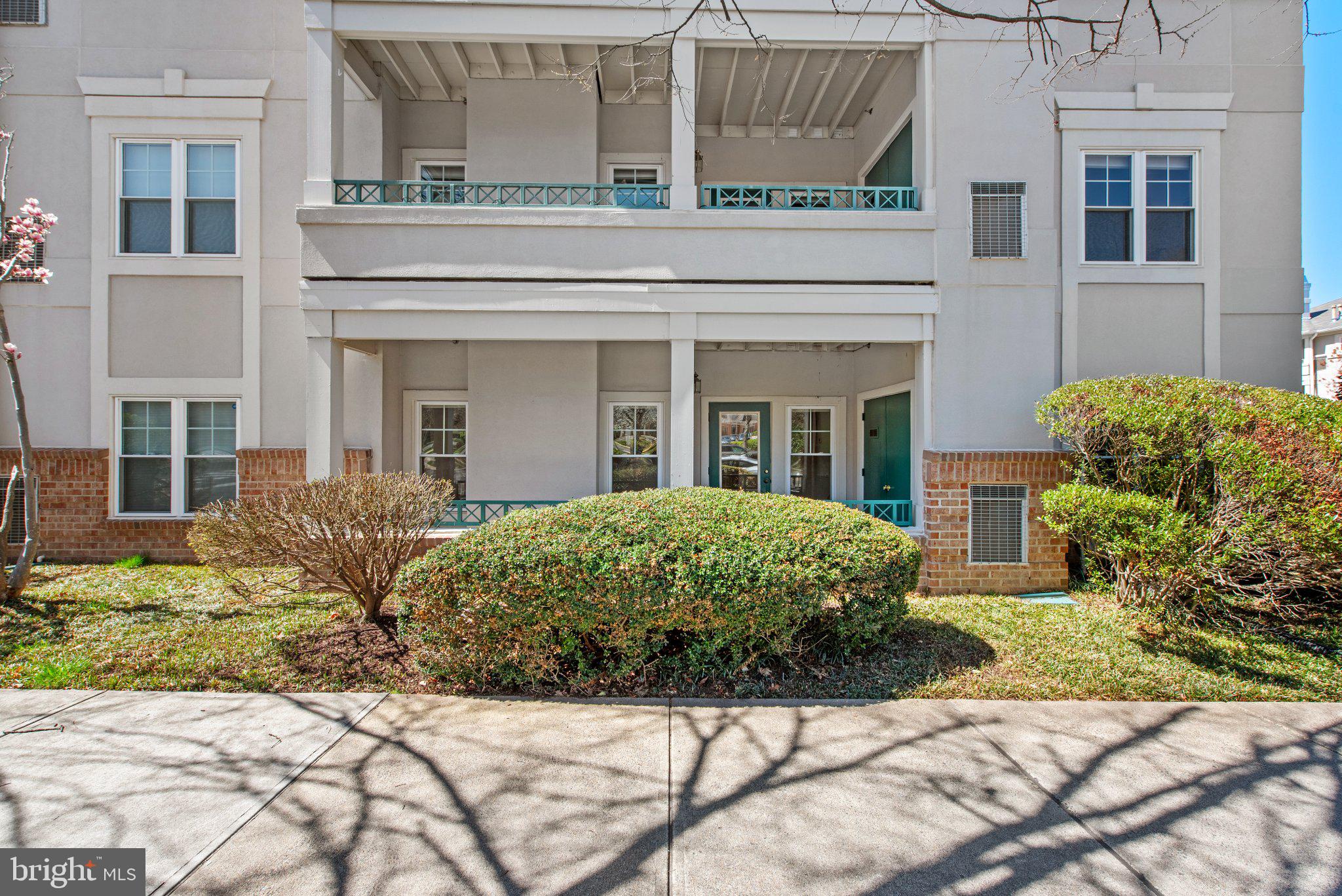 12001 Taliesin Place, Unit 12 Reston, VA 20190 - Photo 20 of 20 Charming facade with lush greenery.