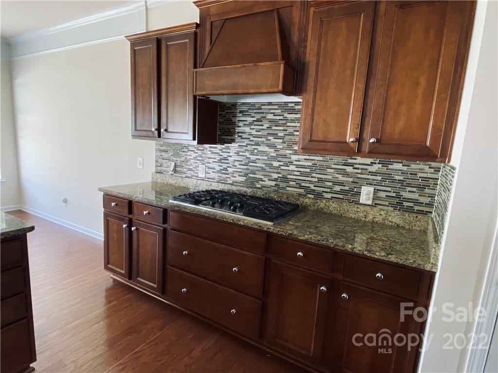 8019 Red Water Road Charlotte, NC 28277 - Photo 4 of 13 a kitchen with stainless steel appliances granite countertop wooden cabinets and a granite counter tops
