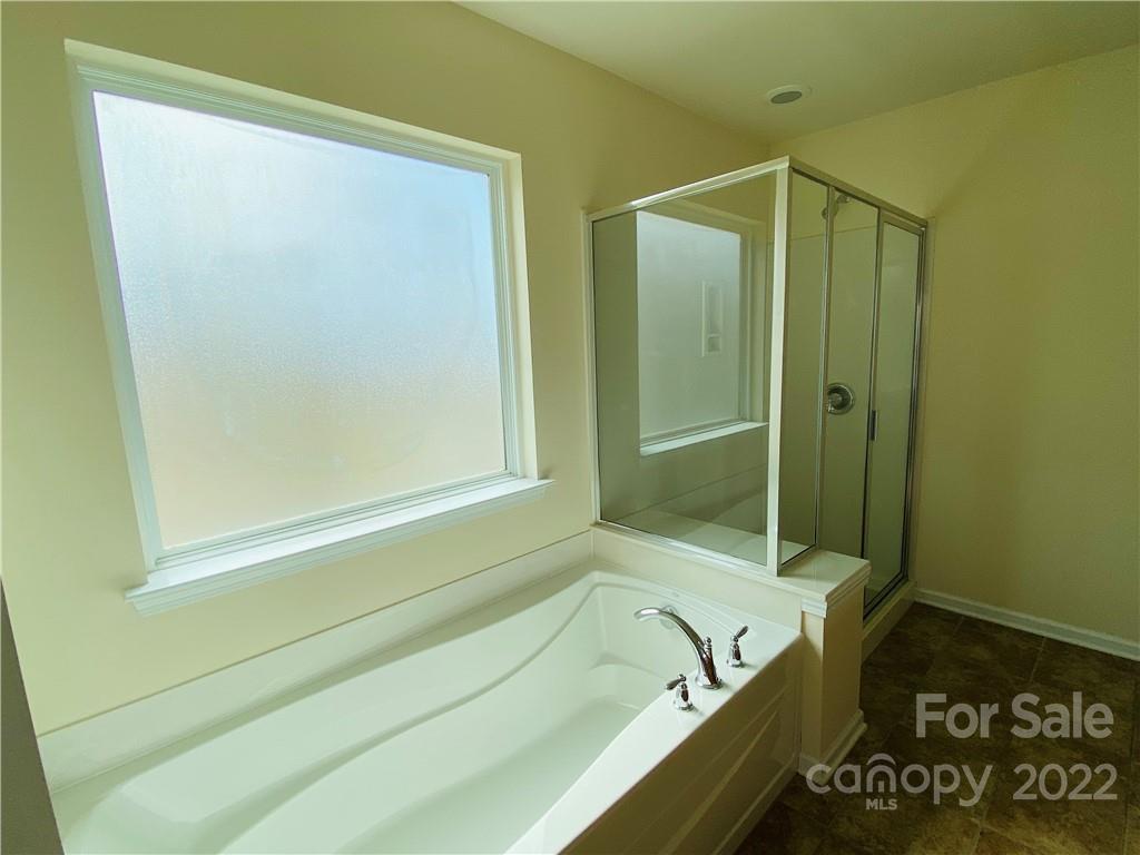 8019 Red Water Road Charlotte, NC 28277 - Photo 8 of 13 a bathroom with a tub and a shower