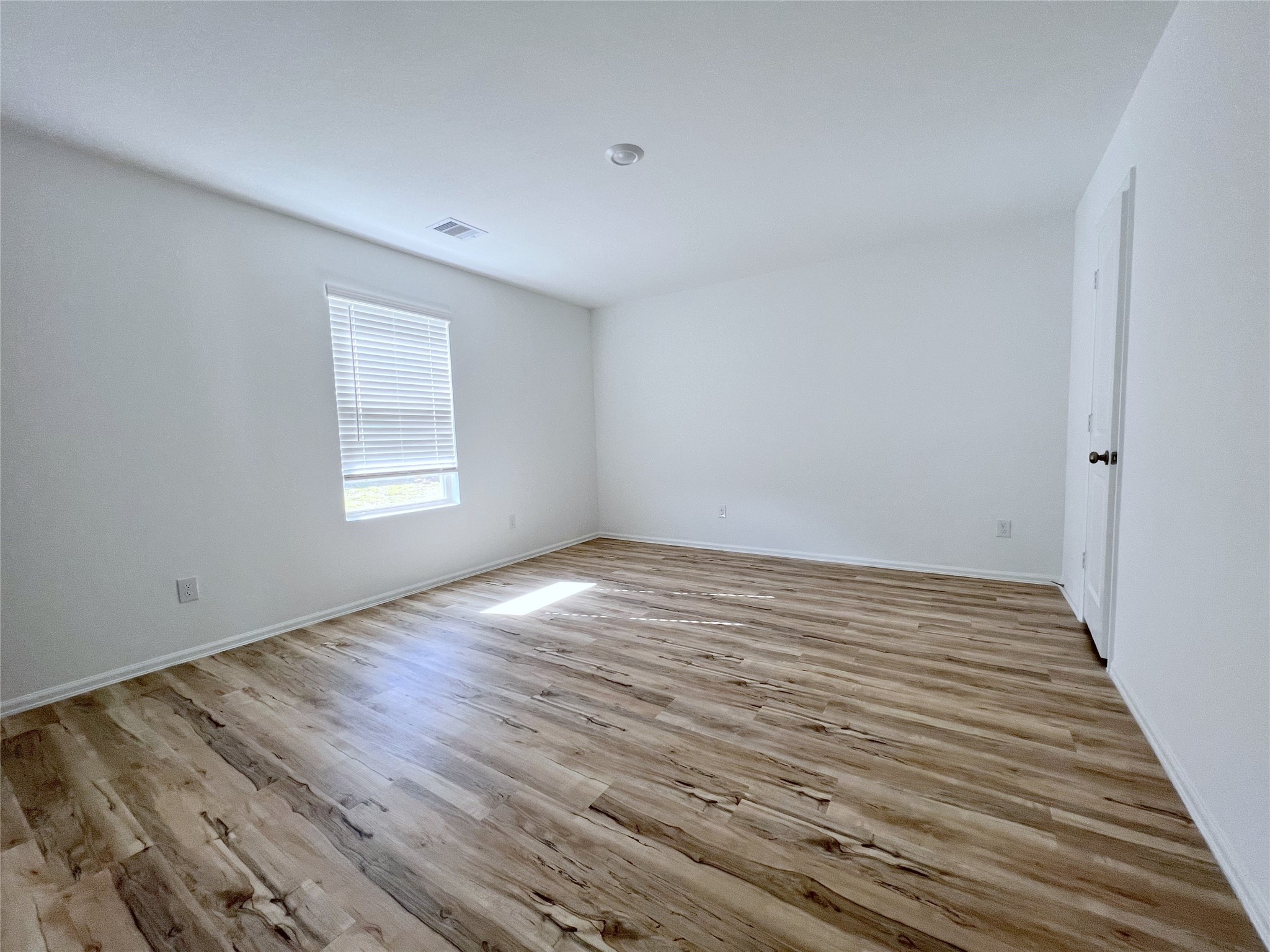 14518 Woodcott Warren Way Rosharon, TX 77583 - Photo 9 of 18 an empty room with wooden floor and windows
