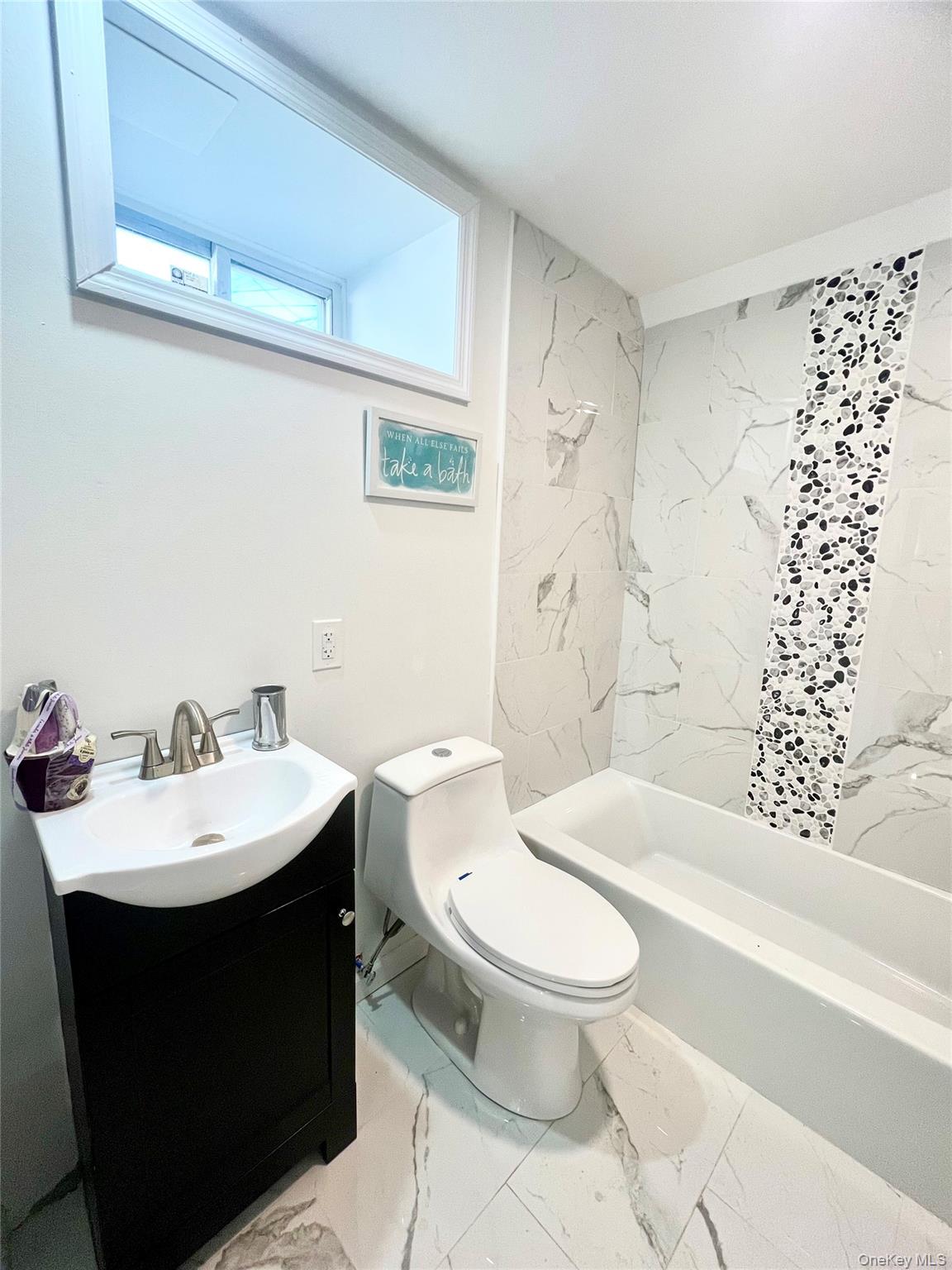 126 West Main Street, Unit 2 Middletown, NY 10940 - Photo 11 of 15 Full bathroom with vanity, light marble finish flooring, and a combined bath / shower with marble appearance