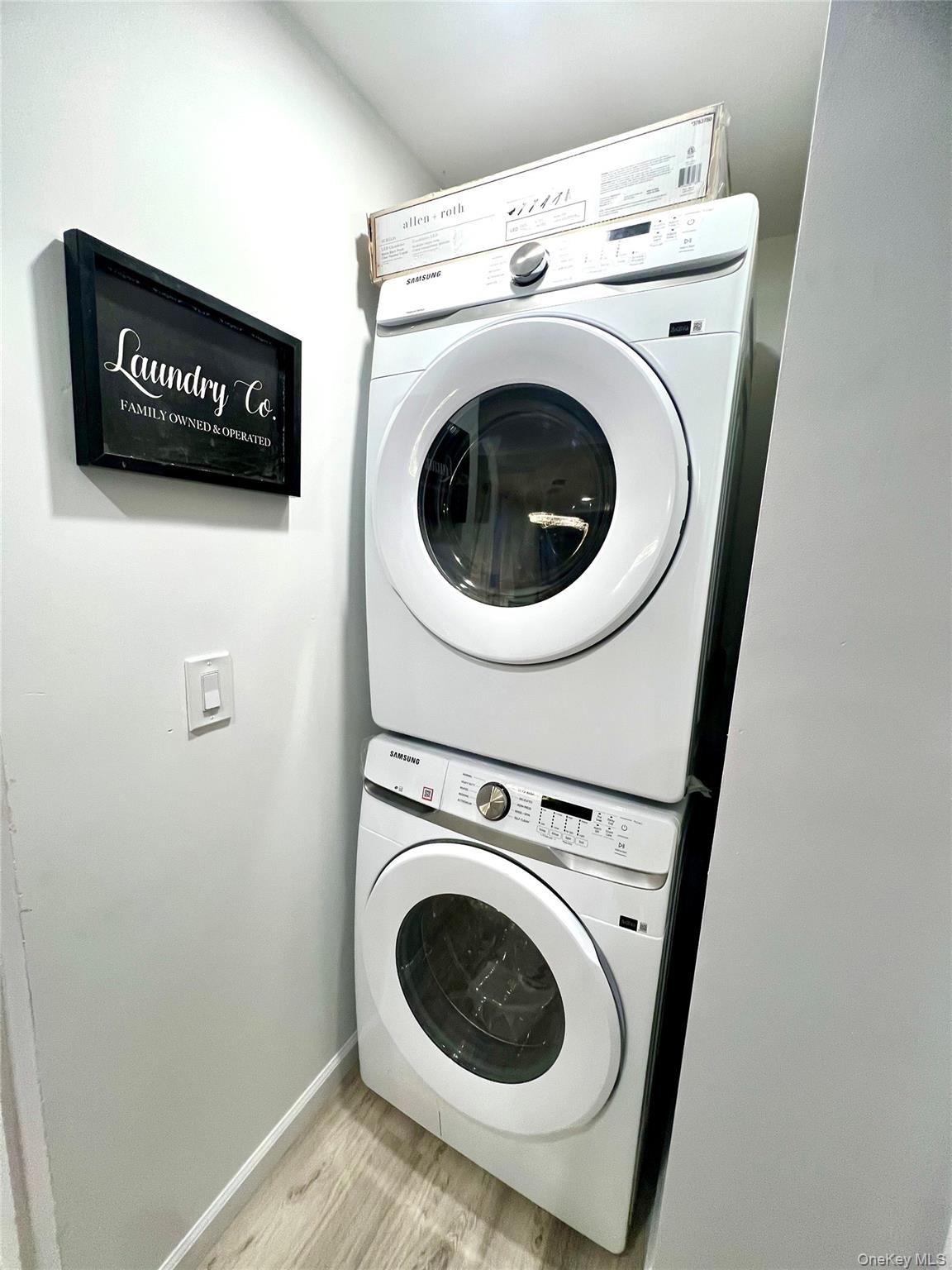 126 West Main Street, Unit 2 Middletown, NY 10940 - Photo 12 of 15 Washroom with stacked washer / dryer and light wood finished floors