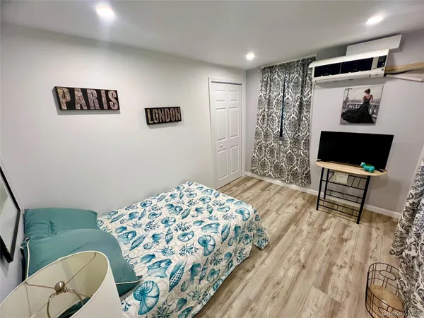 a bedroom with a bed and a chair
