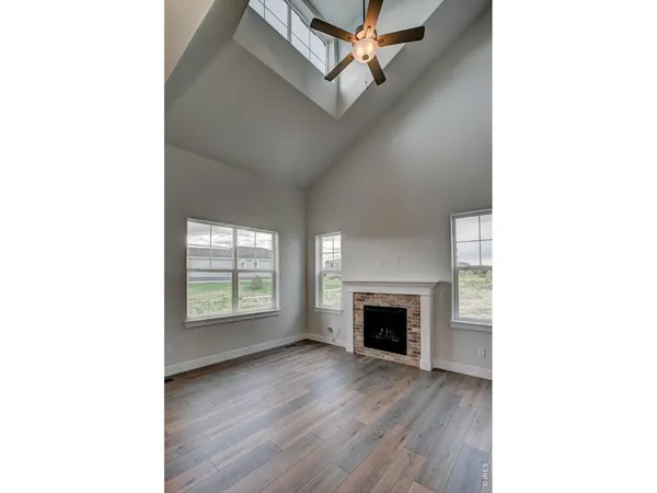 a view of an empty room with a fireplace and a window