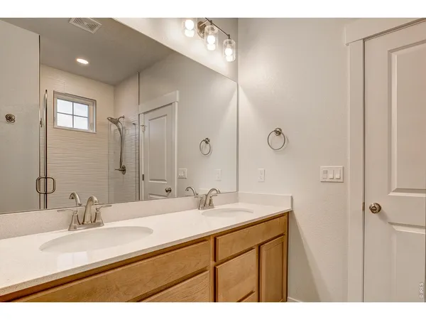a bathroom with a sink double vanity and a mirror
