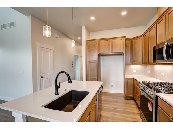 a kitchen with a sink cabinets and stainless steel appliances