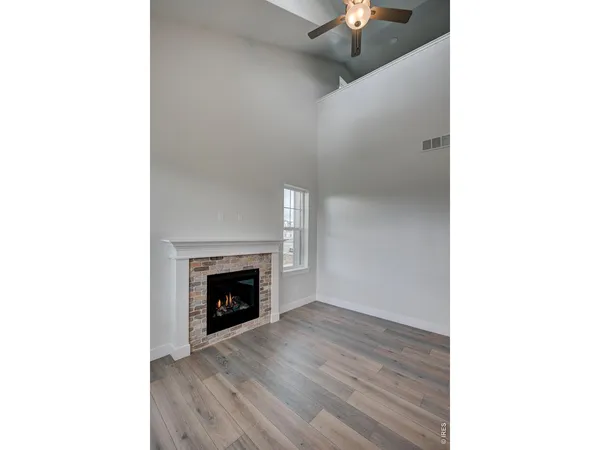 a view of a livingroom with a fireplace and window