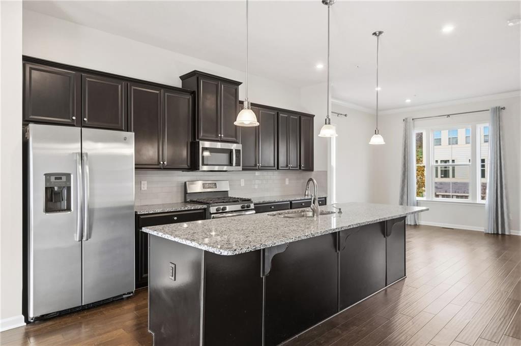 3000 Mahican Circle Mars, PA 16046 - Photo 16 of 39 a kitchen with stainless steel appliances granite countertop a refrigerator a sink a stove a microwave and wooden floors