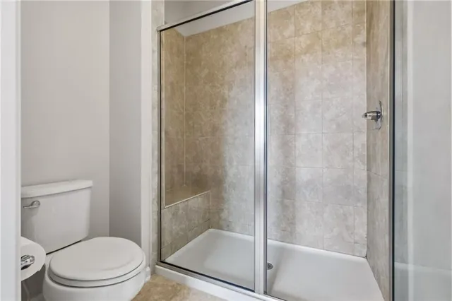 a bathroom with a shower and a toilet